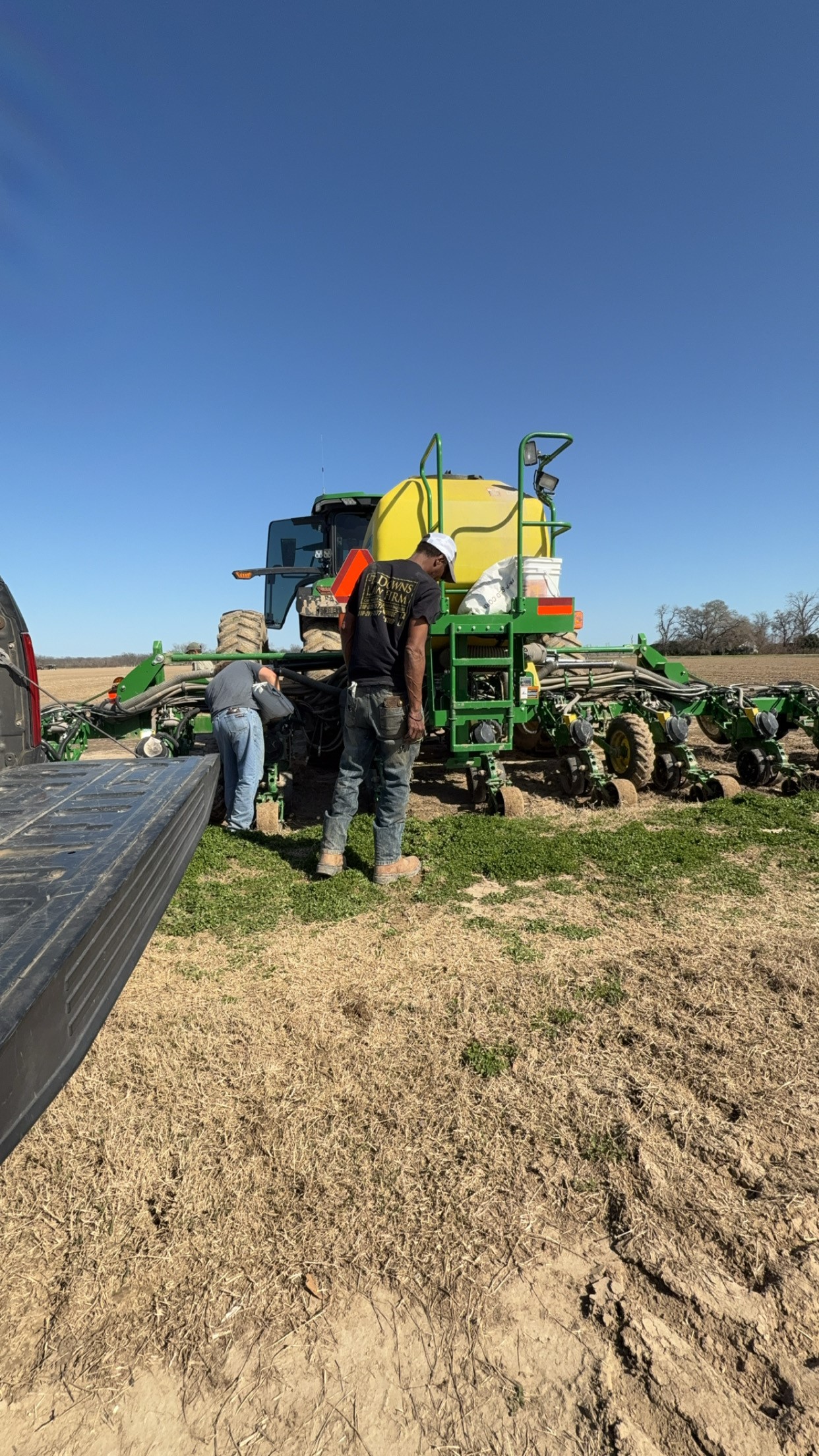 Two people working on a tractor.